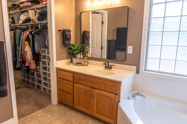 711 Morning Glory Dr, Nixa, MO 65714 - bathroom with vanity, a garden tub, and a walk in closet