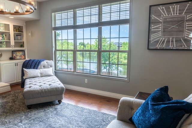 711 Morning Glory Dr, Nixa, MO 65714 - sitting room with plenty of natural light, wood finished floors, baseboards, and a chandelier