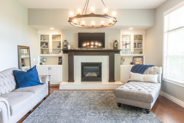 711 Morning Glory Dr, Nixa, MO 65714 - living area with wood finished floors, a chandelier, a tiled fireplace, and baseboards