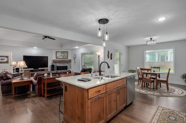 1002 E Tipperary Ct, Nixa, MO 65714 - kitchen with a sink, stainless steel dishwasher, dark wood-style floors, ceiling fan, and a fireplace