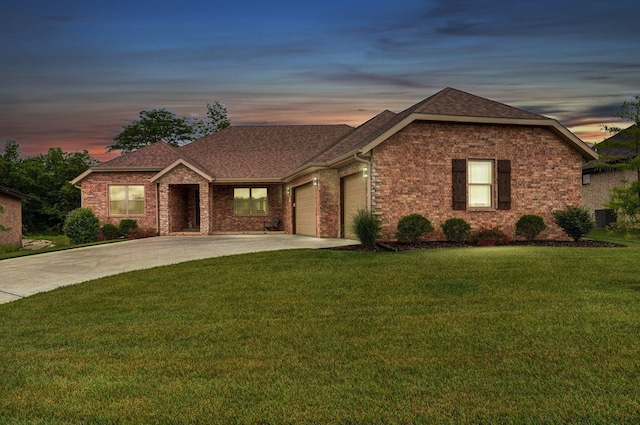 1002 E Tipperary Ct, Nixa, MO 65714 - view of front of home with a garage, concrete driveway, a front lawn, brick siding, and roof with shingles