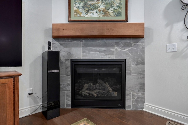 1002 E Tipperary Ct, Nixa, MO 65714 - detailed view of wood finished floors, a tiled fireplace, and baseboards