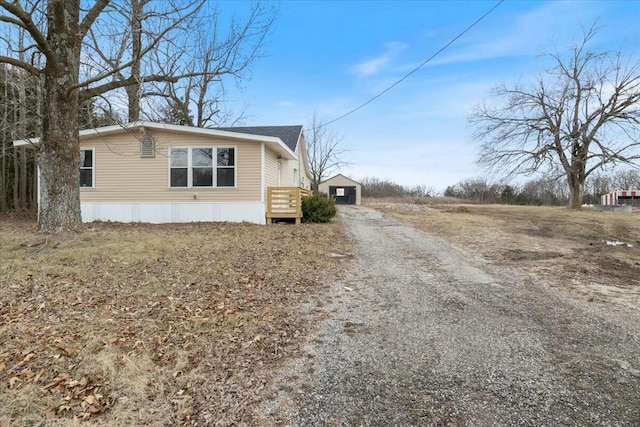 2845 US Highway 65, Urbana, MO 65767 - view of home's exterior with driveway, an outbuilding, and a garage