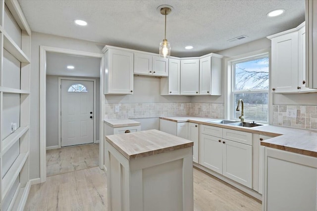 2845 US Highway 65, Urbana, MO 65767 - kitchen with a sink, hanging light fixtures, recessed lighting, backsplash, and butcher block countertops