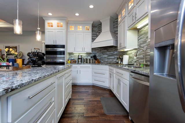 992 N Cedar Ridge Ave, Springfield, MO 65802 - kitchen with stainless steel appliances, a sink, custom range hood, recessed lighting, and white cabinets