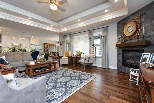992 N Cedar Ridge Ave, Springfield, MO 65802 - living room with a tray ceiling, crown molding, ceiling fan, a fireplace, and hardwood / wood-style floors