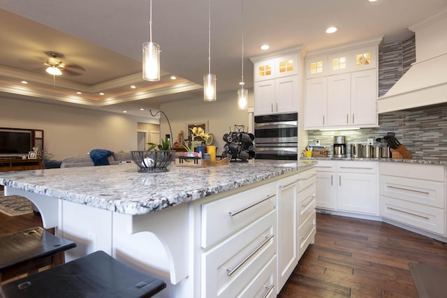 992 N Cedar Ridge Ave, Springfield, MO 65802 - kitchen with double oven, ornamental molding, a raised ceiling, backsplash, and open floor plan