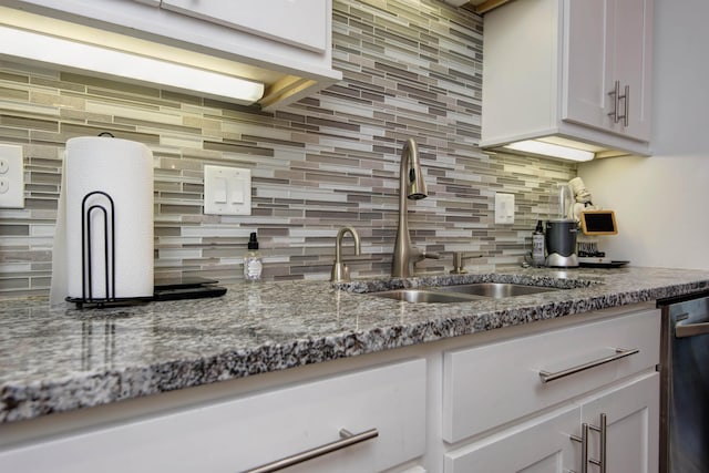 992 N Cedar Ridge Ave, Springfield, MO 65802 - kitchen featuring a sink, tasteful backsplash, dark stone countertops, dishwasher, and white cabinets