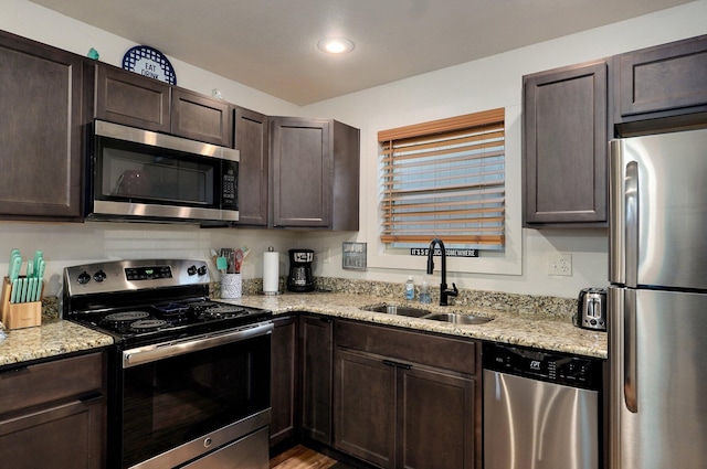 4656 W State Highway H Unit 3, Lampe, MO 65681 - kitchen featuring appliances with stainless steel finishes, a sink, dark brown cabinetry, light stone countertops, and recessed lighting