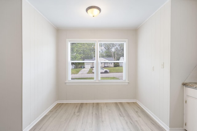 1116 W University St, Springfield, MO 65807 - unfurnished dining area featuring light wood-style flooring and baseboards