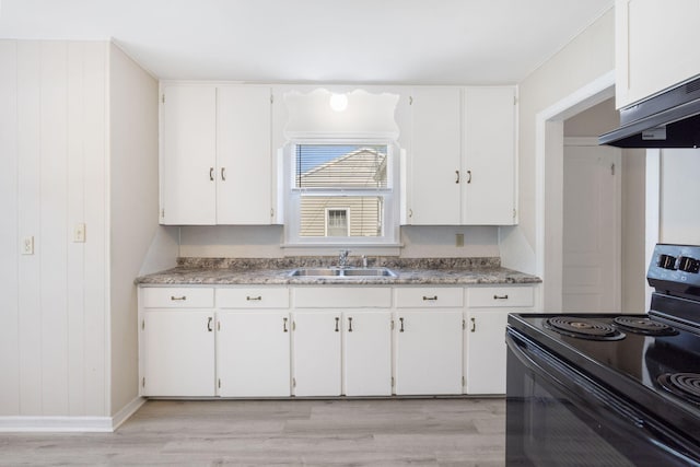 1116 W University St, Springfield, MO 65807 - kitchen with black range with electric stovetop, a sink, and white cabinetry