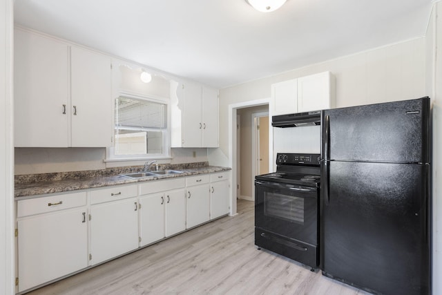 1116 W University St, Springfield, MO 65807 - kitchen featuring black appliances, under cabinet range hood, a sink, white cabinetry, and light wood-type flooring
