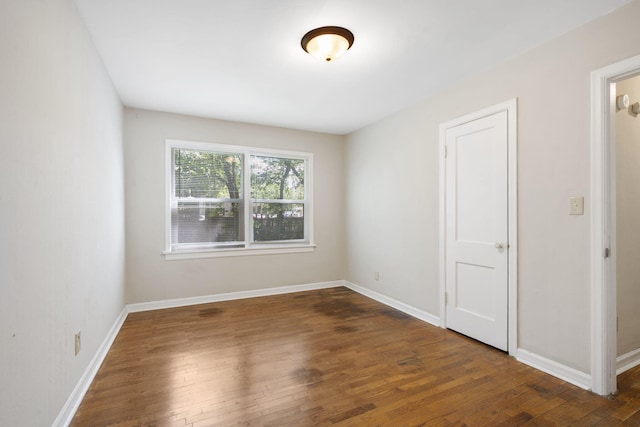 1116 W University St, Springfield, MO 65807 - spare room featuring wood finished floors and baseboards