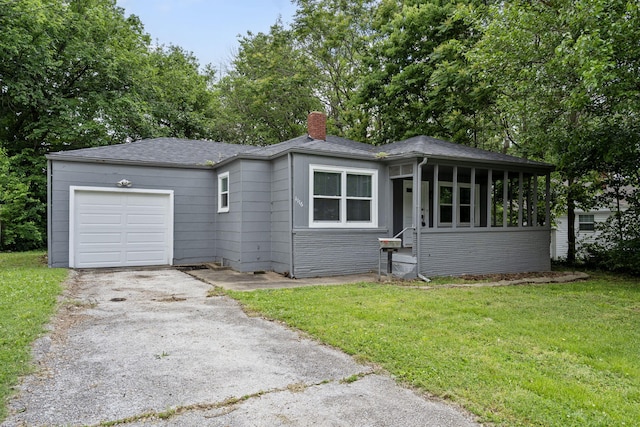 1116 W University St, Springfield, MO 65807 - view of front facade with driveway, a chimney, a garage, a front lawn, and a sunroom