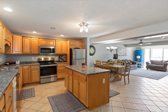 783 Winn Rd Unit 5B, Osage Beach, MO 65065 - kitchen featuring stainless steel appliances, a sink, light tile patterned flooring, recessed lighting, and open floor plan