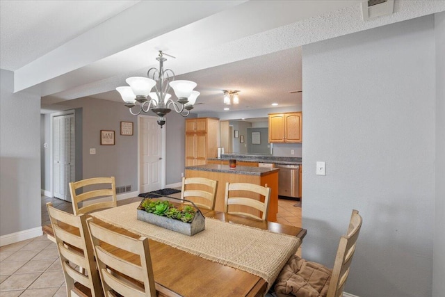 783 Winn Rd Unit 5B, Osage Beach, MO 65065 - dining area featuring a chandelier, light tile patterned floors, and baseboards