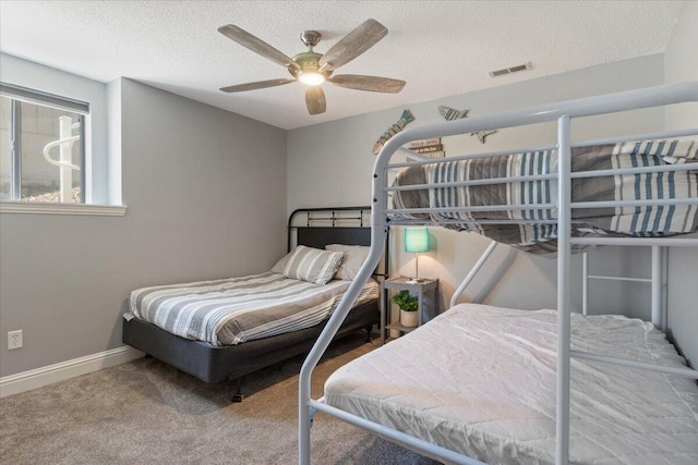 783 Winn Rd Unit 5B, Osage Beach, MO 65065 - carpeted bedroom featuring a textured ceiling, baseboards, and a ceiling fan