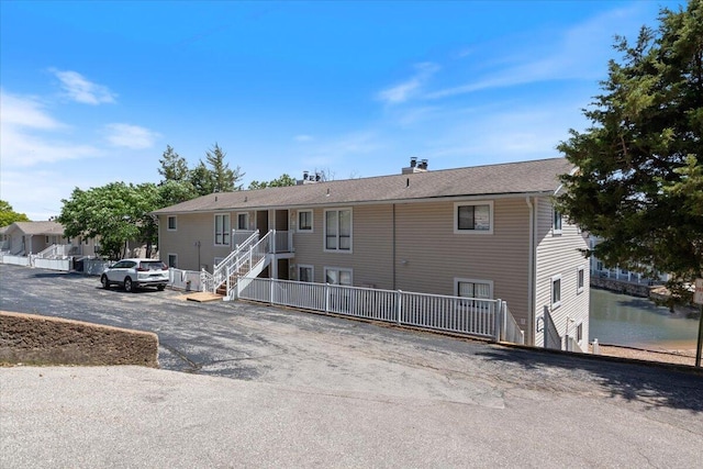 783 Winn Rd Unit 5B, Osage Beach, MO 65065 - rear view of house featuring a chimney and uncovered parking