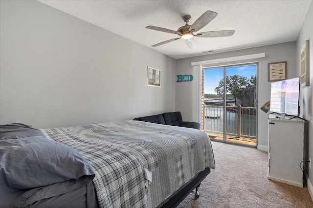 783 Winn Rd Unit 5B, Osage Beach, MO 65065 - carpeted bedroom featuring access to exterior, a textured ceiling, a ceiling fan, and baseboards