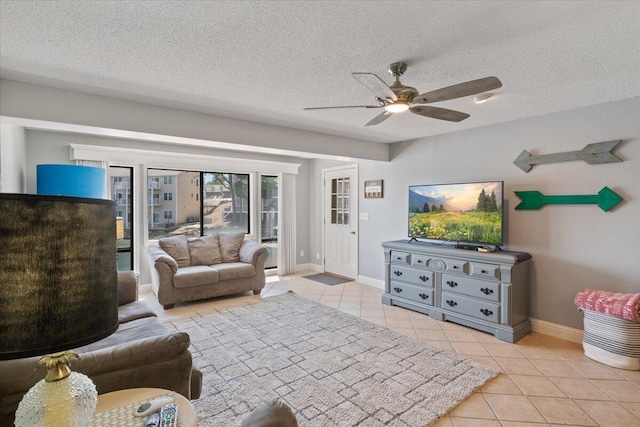 783 Winn Rd Unit 5B, Osage Beach, MO 65065 - living area with tile patterned flooring, a ceiling fan, baseboards, and a textured ceiling