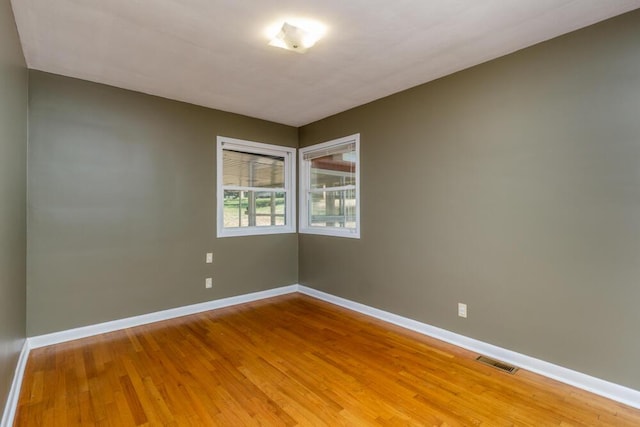 1318 S Farm Rd Unit 205, Springfield, MO 65809 - spare room featuring baseboards and light wood-style flooring