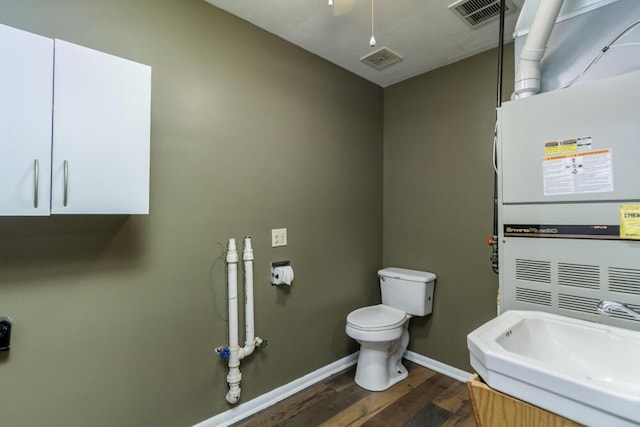 1318 S Farm Rd Unit 205, Springfield, MO 65809 - bathroom with a sink, baseboards, wood finished floors, toilet, and heating unit