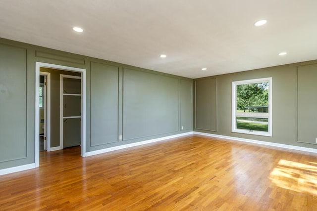 1318 S Farm Rd Unit 205, Springfield, MO 65809 - empty room featuring a decorative wall, recessed lighting, and light wood finished floors