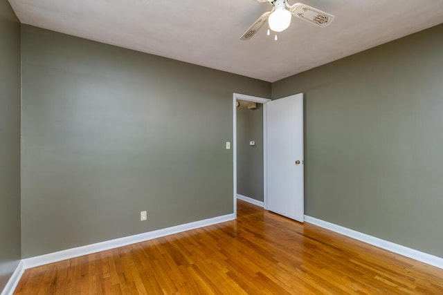 1318 S Farm Rd Unit 205, Springfield, MO 65809 - unfurnished room featuring baseboards, wood finished floors, and a ceiling fan