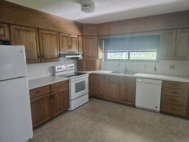 407 N Crestview Ave, Ash Grove, MO 65604 - kitchen featuring white appliances, under cabinet range hood, a sink, brown cabinetry, and decorative backsplash