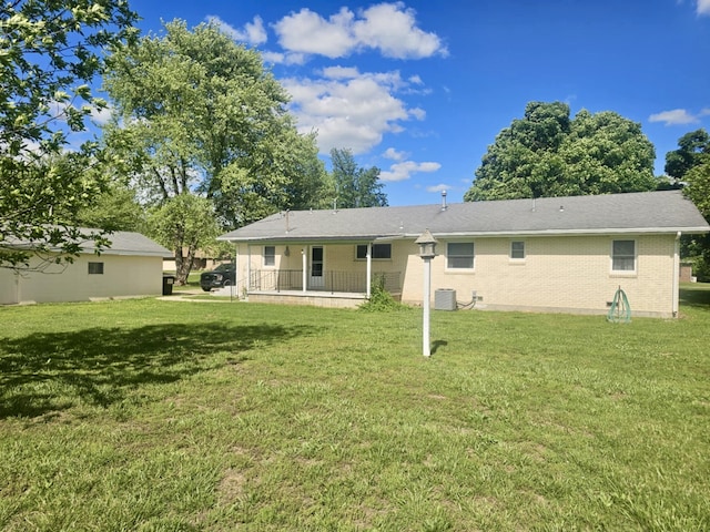 407 N Crestview Ave, Ash Grove, MO 65604 - rear view of house featuring a lawn, brick siding, and central air condition unit