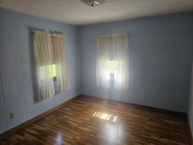 407 N Crestview Ave, Ash Grove, MO 65604 - empty room featuring dark wood-style flooring, baseboards, and a textured ceiling