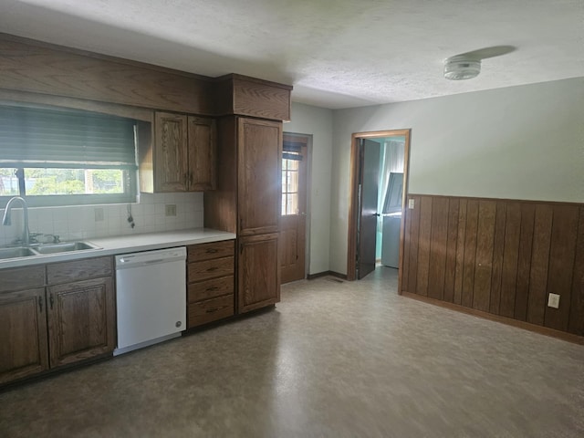 407 N Crestview Ave, Ash Grove, MO 65604 - kitchen with dishwasher, a sink, light countertops, a wainscoted wall, and wood walls