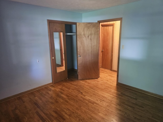 407 N Crestview Ave, Ash Grove, MO 65604 - unfurnished bedroom featuring wood finished floors, baseboards, and a closet