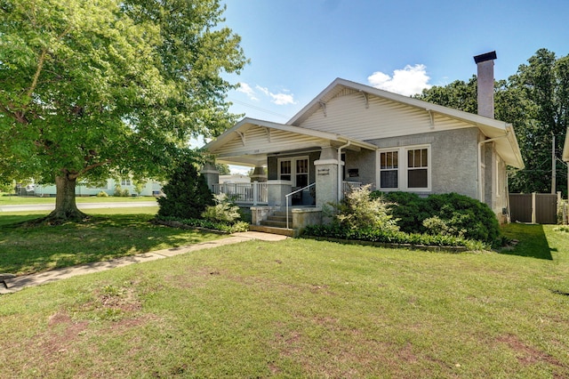 559 E Pleasant St, Mount Vernon, MO 65712 - view of front facade featuring covered porch, a chimney, and a front yard