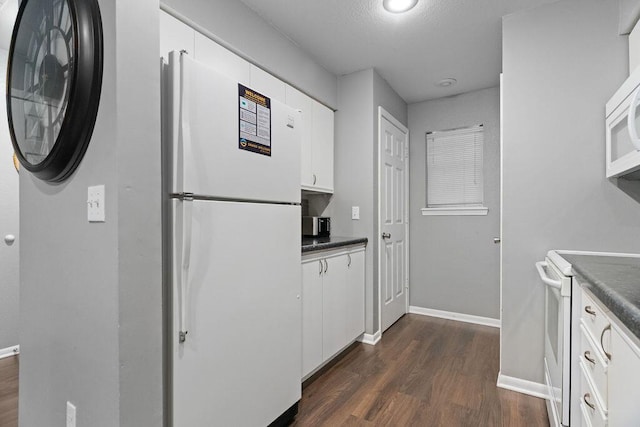 175 W Rockford Dr Unit 6, Branson, MO 65616 - kitchen featuring white appliances, dark wood finished floors, dark countertops, white cabinets, and baseboards
