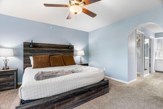 175 W Rockford Dr Unit 6, Branson, MO 65616 - carpeted bedroom with arched walkways, baseboards, a ceiling fan, and ensuite bathroom