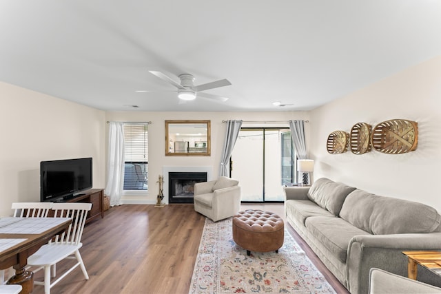 264 Turnberry Dr Unit 2, Branson, MO 65615 - living room featuring a ceiling fan, light wood-style flooring, a fireplace, and baseboards