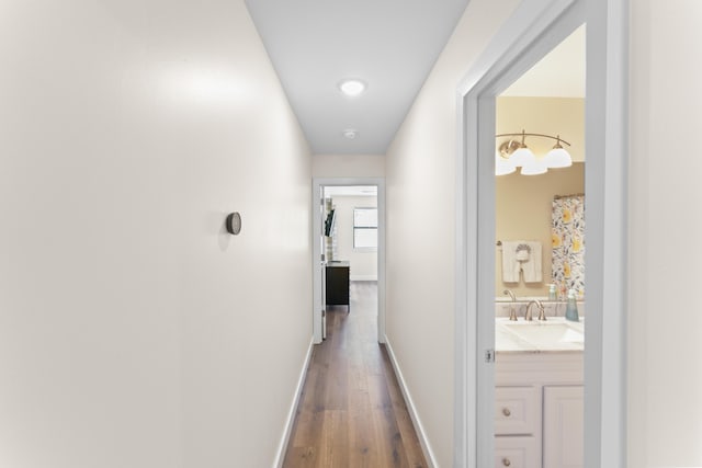 264 Turnberry Dr Unit 2, Branson, MO 65615 - hallway featuring a sink, dark wood-style flooring, and baseboards