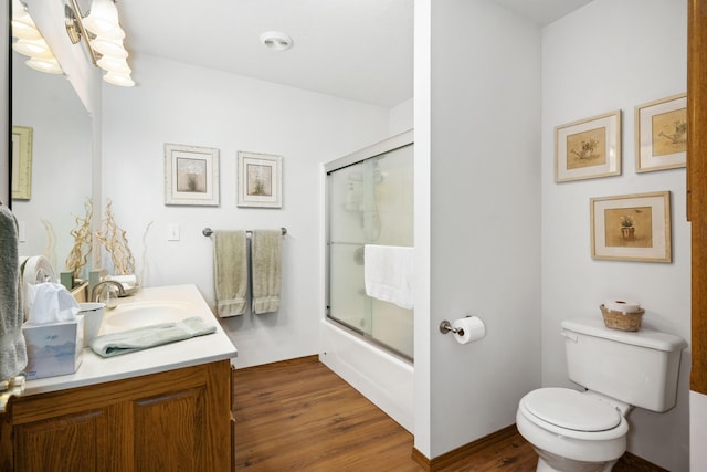 1362 Meadowview Ln, Diamond, MO 64840 - bathroom with wood finished floors, toilet, vanity, and bath / shower combo with glass door