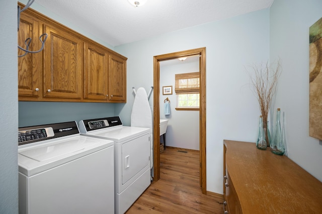 1362 Meadowview Ln, Diamond, MO 64840 - laundry area with cabinet space, separate washer and dryer, and light wood finished floors