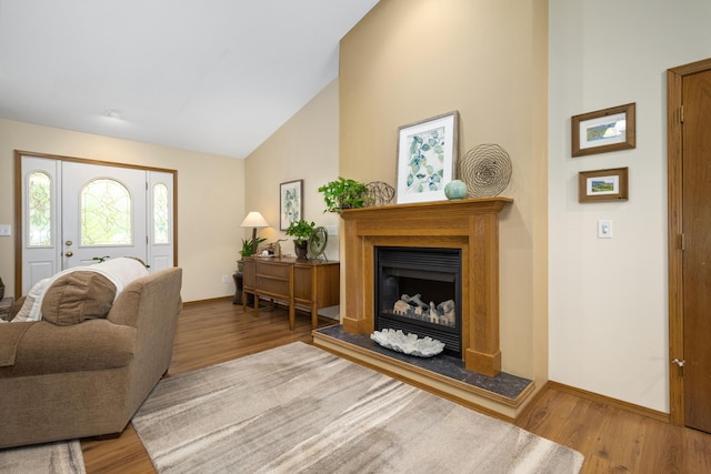 1362 Meadowview Ln, Diamond, MO 64840 - living room with wood finished floors, a fireplace with raised hearth, baseboards, and lofted ceiling