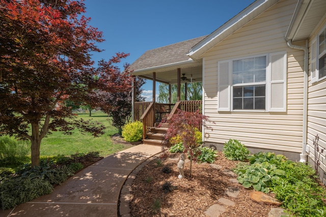 1362 Meadowview Ln, Diamond, MO 64840 - doorway to property with ceiling fan, roof with shingles, a porch, and a lawn