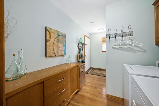 1362 Meadowview Ln, Diamond, MO 64840 - laundry room featuring washer and dryer, light wood-style floors, cabinet space, and baseboards