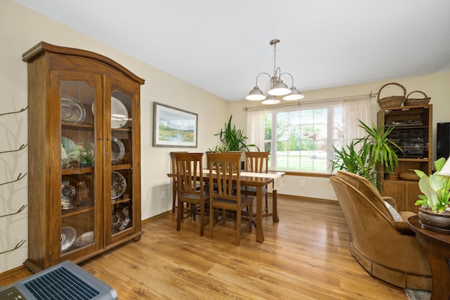 1362 Meadowview Ln, Diamond, MO 64840 - dining room with light wood-type flooring, a chandelier, and baseboards
