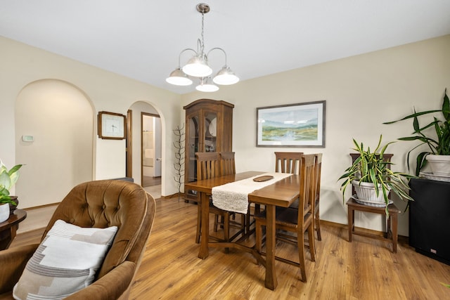 1362 Meadowview Ln, Diamond, MO 64840 - dining room featuring arched walkways, light wood finished floors, and baseboards