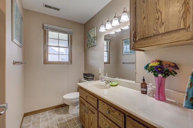 707 Lexie Ln, Carthage, MO 64836 - bathroom with toilet, vanity, baseboards, and plenty of natural light