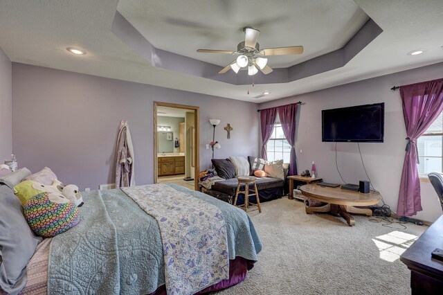 707 Lexie Ln, Carthage, MO 64836 - carpeted bedroom with a tray ceiling, ceiling fan, recessed lighting, and connected bathroom
