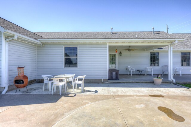 707 Lexie Ln, Carthage, MO 64836 - rear view of property featuring ceiling fan, roof with shingles, a patio, and outdoor dining space