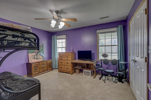 707 Lexie Ln, Carthage, MO 64836 - carpeted bedroom featuring a ceiling fan, a textured ceiling, and a closet