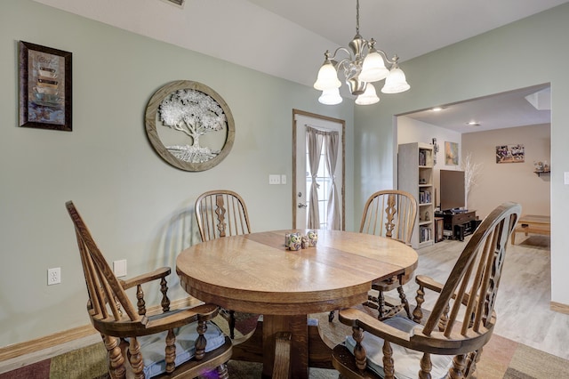 707 Lexie Ln, Carthage, MO 64836 - dining space with a chandelier, baseboards, and light wood finished floors